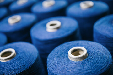 Cotton yarns or threads on spool tube bobbins at cotton yarn factory.