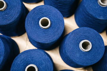 Cotton yarns or threads on spool tube bobbins at cotton yarn factory.