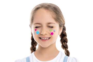 girl with closed eyes and multicolored stars on face smiling isolated on white.