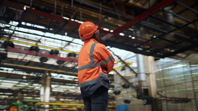 Afro american supervisor thinking about project work at production warehouse.