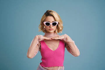 Young white woman in sunglasses gesturing and looking at camera