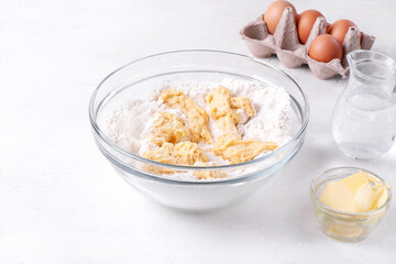 Making yeast bakery product. Adding sourdough into flour, sugar, butter and water in the glass bowl. Preparing buns, Easter cake or pie. Step by step recipe. Step 3