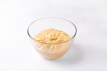 Kneading yeast dough in the glass bowl. Process of proofing and fermentation. Preparing buns, Easter cake or pie. Step by step recipe. Step 5