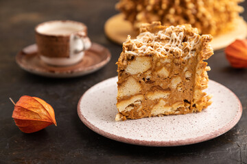 Traditional lithuanian cake shakotis with cup of coffee on black, side view, copy space, selective focus.
