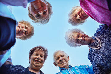 Growing old gracefully together. Low angle shot of a group of seniors outside.
