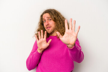 Young caucasian man isolated on white background being shocked due to an imminent danger
