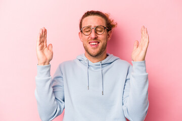 Young caucasian man isolated on pink background joyful laughing a lot. Happiness concept.