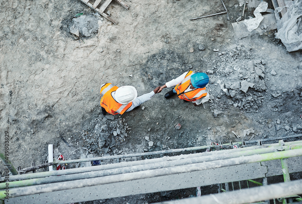 Poster We dont just built properties, we build relationships. Shot of two builders shaking hands at a construction site.