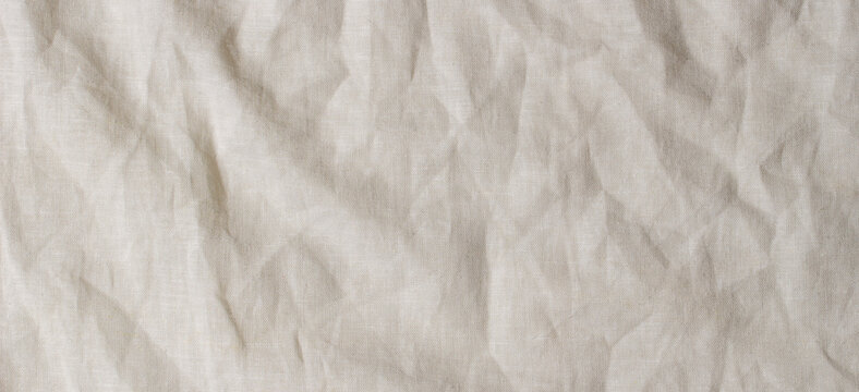 Abstract linen fabric texture background. Crumpled off white natural linen organic eco textiles canvas background. Top view