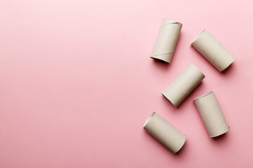 Flat lay composition with empty toilet paper rolls and space for text on color background. Recyclable paper tube with metal plug end made of kraft paper or cardboard