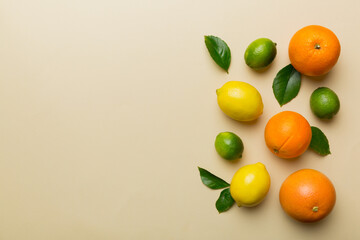 Fruit background. Colorful fresh fruits on colored table. Orange, lemon, grapefruit Space for text healthy concept. Flat lay, top view, copy space