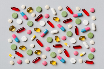 Many different pills and space for text on colorful background, top view. Different pills on color background, flat lay