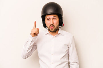 Hispanic business man going to work with motorcycle isolated on white background having some great idea, concept of creativity.