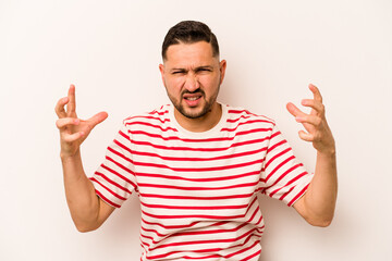 Young hispanic man isolated on white background screaming with rage.