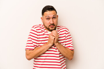 Young hispanic man isolated on white background scared and afraid.