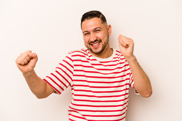 Young hispanic man isolated on white background dancing and having fun.