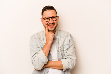 Young hispanic man isolated on white background smiling happy and confident, touching chin with hand.