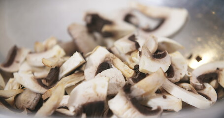 Chef Slicing Mushrooms in Kitchen