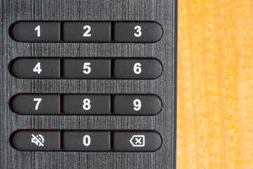 Number buttons on the remote control. Black TV remote control close up. Сhanging and setting channels.