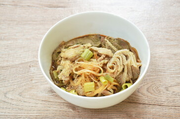 boiled thin rice noodles topping slice beef meat and liver in brown soup on bowl