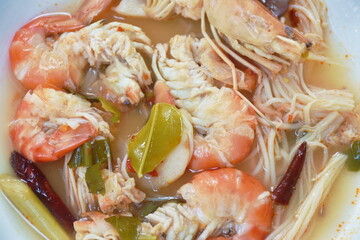 boiled river shrimp with herb in Thai spicy soup or tom yum kung on plate