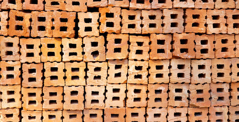 Stack of red bricks, orange clay bricks