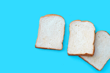 Sliced of bread on blue background.