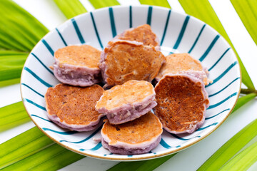 Coconut pancake in plate on green leaves