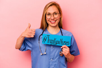 Young nurse woman holding thank you nurses placard isolated on pink background