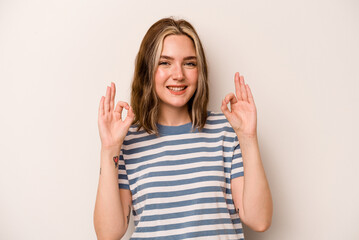 Young caucasian woman isolated on white background cheerful and confident showing ok gesture.