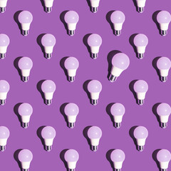 Pattern made of led bulb lamp with one different on pastel purple background. Energy saving idea