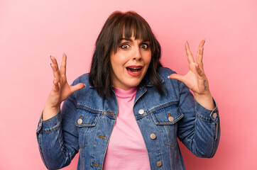 Young caucasian woman isolated on pink background screaming to the sky, looking up, frustrated.