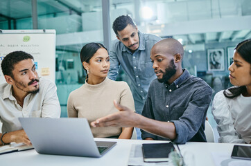 I think we have some changes to make. Shot of a group of businesspeople using a laptop during a meeting.