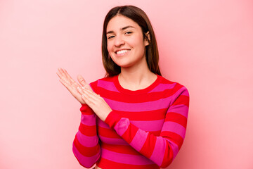 Young caucasian woman isolated on pink background feeling energetic and comfortable, rubbing hands confident.