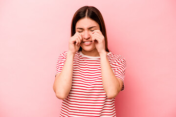 Young caucasian woman isolated on pink background whining and crying disconsolately.