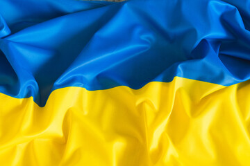 Real fabric waving flag of Ukraine. National yellow and blue Ukrainian flag for Independence day