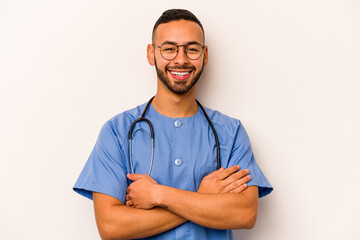 Young hispanic nurse man isolated on white background laughing and having fun.