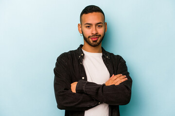 Young hispanic man isolated on blue background happy, smiling and cheerful.