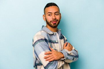 Fototapeta premium Young hispanic man isolated on blue background laughing and having fun.