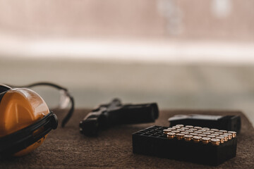 The sniper is preparing to hit the target. Guns and shooting equipment in the shooting range