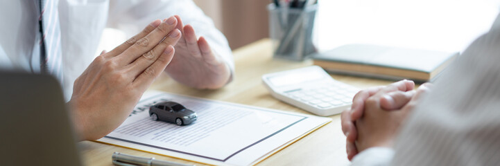 Insurance concept the car merchant presenting the function and condition of the car by using a car...