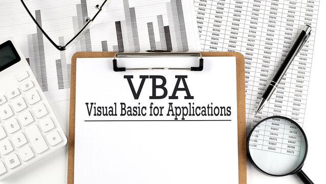 Paper with Visual Basic for Applications VBA on a chart with calculator,pen and magnifier