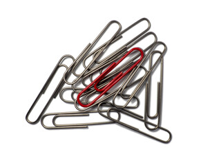 Metal paper clips on a white background. Office supplies isolate. Idea. The concept of loneliness. Confrontation. Stands out from the crowd.