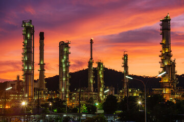 Obraz na płótnie Canvas Oil​ refinery​ and​ plant and tower column of Petrochemistry industry in oil​ and​ gas​ ​industrial with​ cloud​ red​ ​sky the evening​ sunset