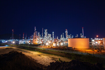Twilight scene of oil refinery plant and storage white tank oil of Petrochemistry industry