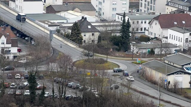 Time lapse of roundabout traffic on a cloudy day in Herborn, Germany. Static telephoto footage