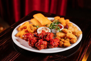 Assorted beer snacks with sauce.