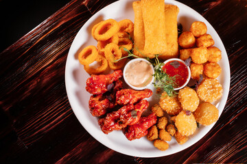 Assorted beer snacks with sauce top view.