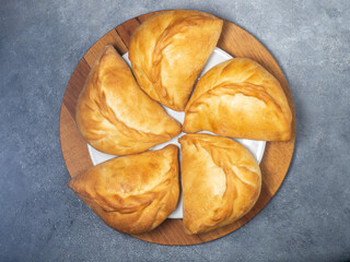 National bakery. A pie with cabbage. Pies with stuffing on the table. Cuisine of the countries of the world.