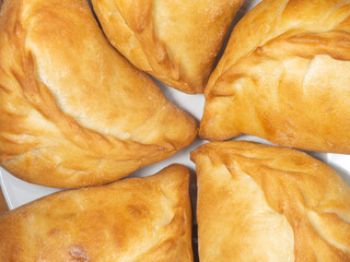 National bakery. A pie with cabbage. Pies with stuffing on the table. Cuisine of the countries of the world.